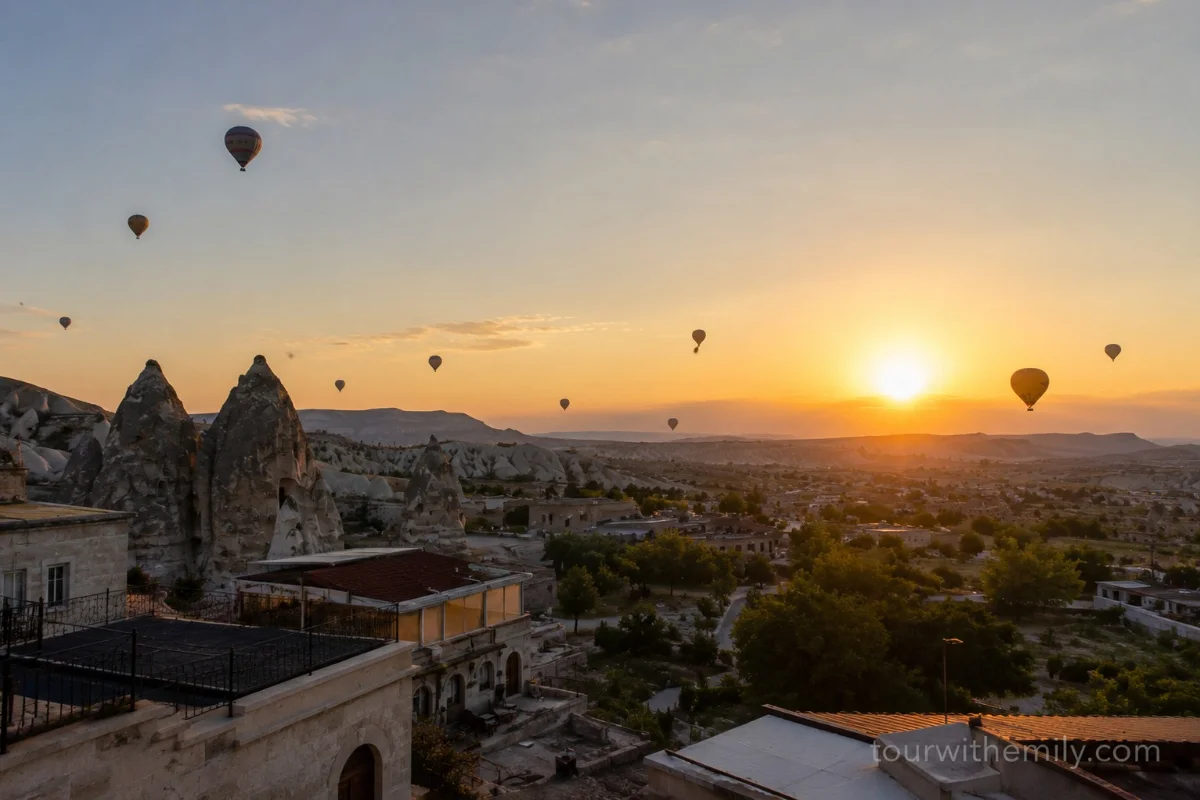 Hot air balloons floating over Cappadocia fairy chimneys and valleys at sunrise