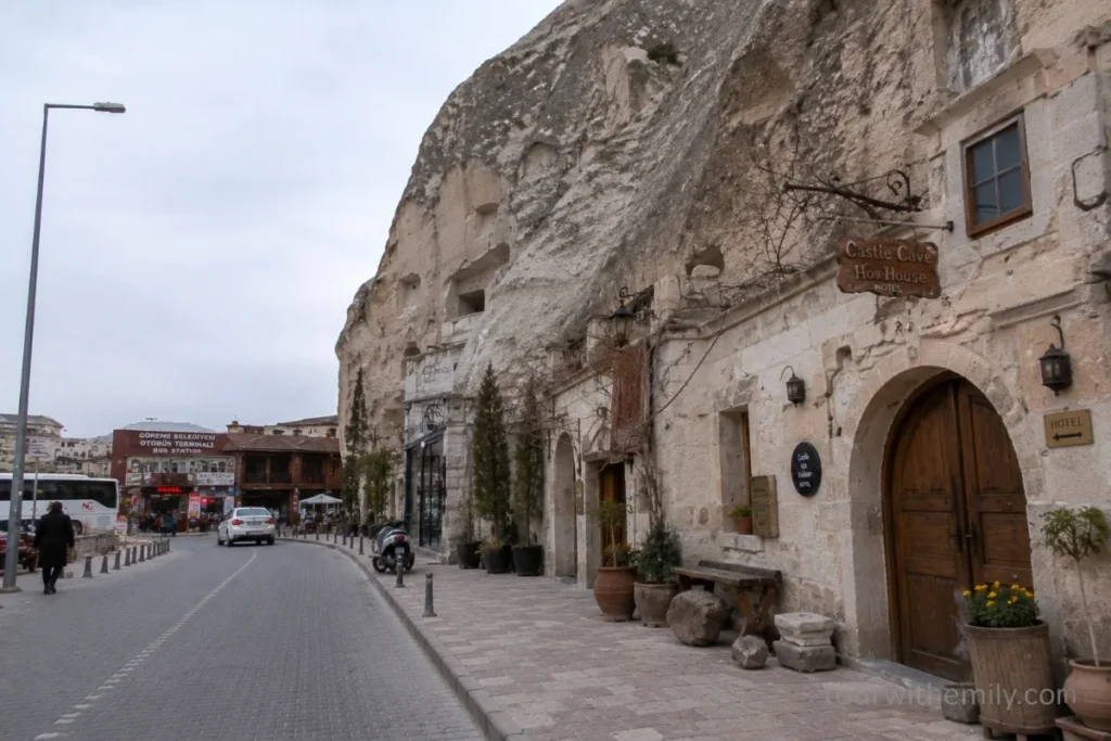 Street view of budget cave hotels carved into the hillside in Göreme Cappadocia near the town center