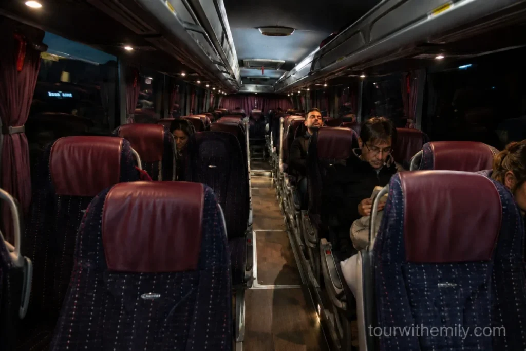 Interior of a Turkish long-distance overnight bus with wide reclining seats and aisle lighting