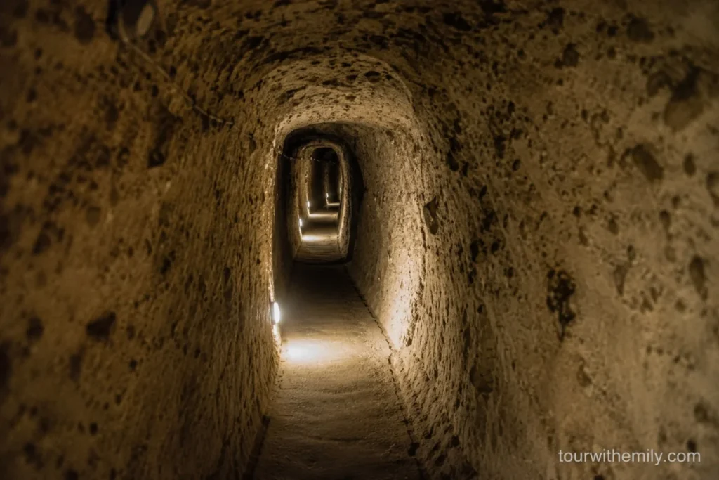 Narrow carved rock tunnel inside Derinkuyu underground city Cappadocia with low stone ceiling