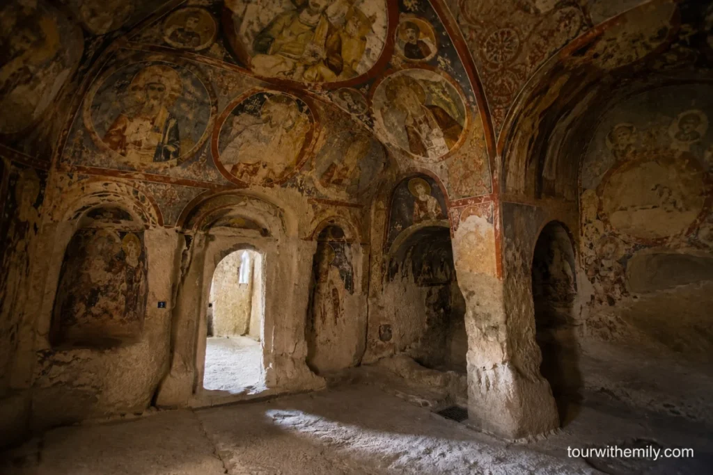 Interior of a Byzantine cave church in the Göreme Open Air Museum with ancient frescoes on the rock ceiling