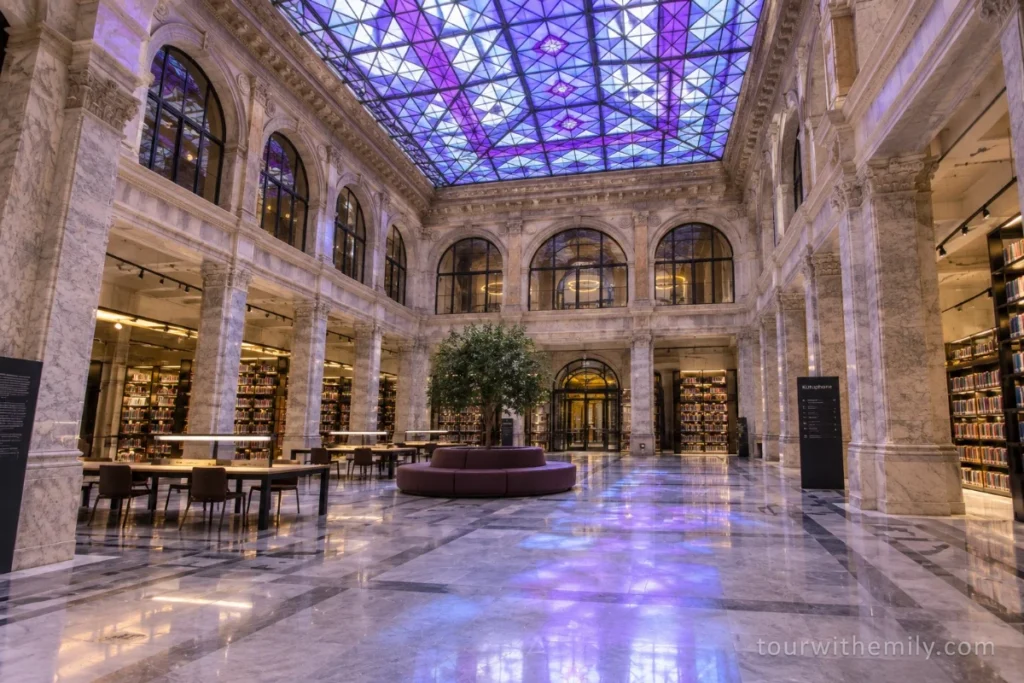 The interior atrium of Salt Galata in Istanbul with purple and blue stained glass ceiling and marble floors