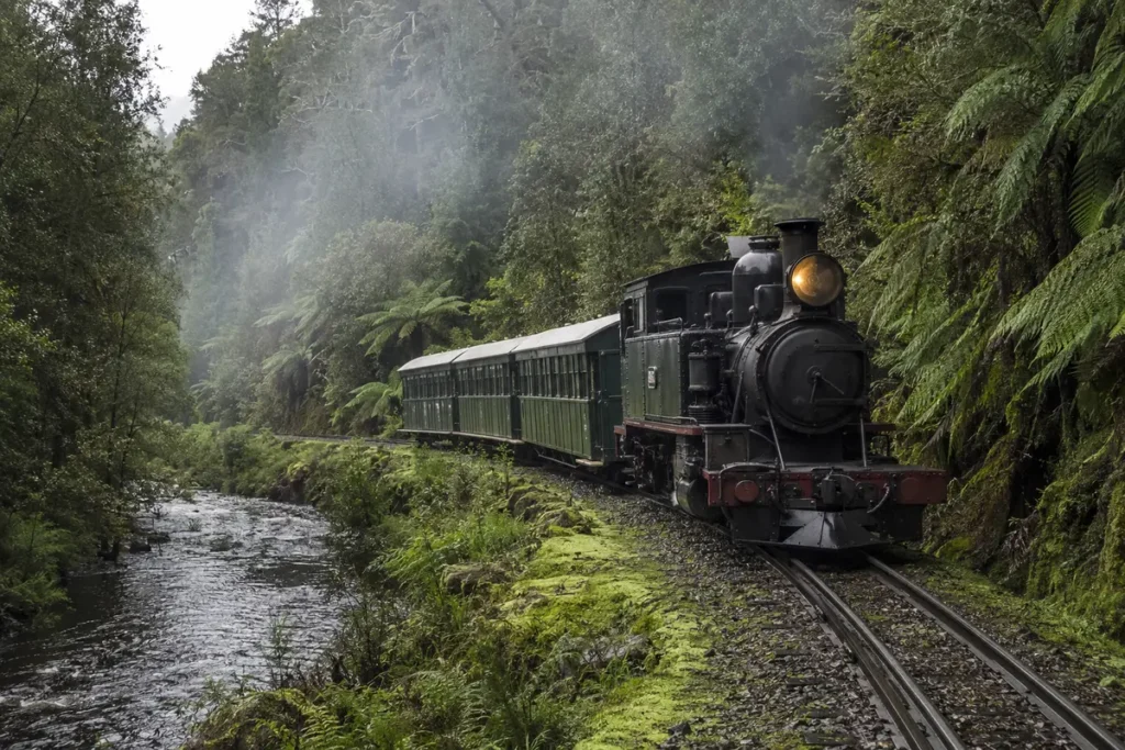 West Coast Wilderness Railway steam train travelling through Tasmanian rainforest